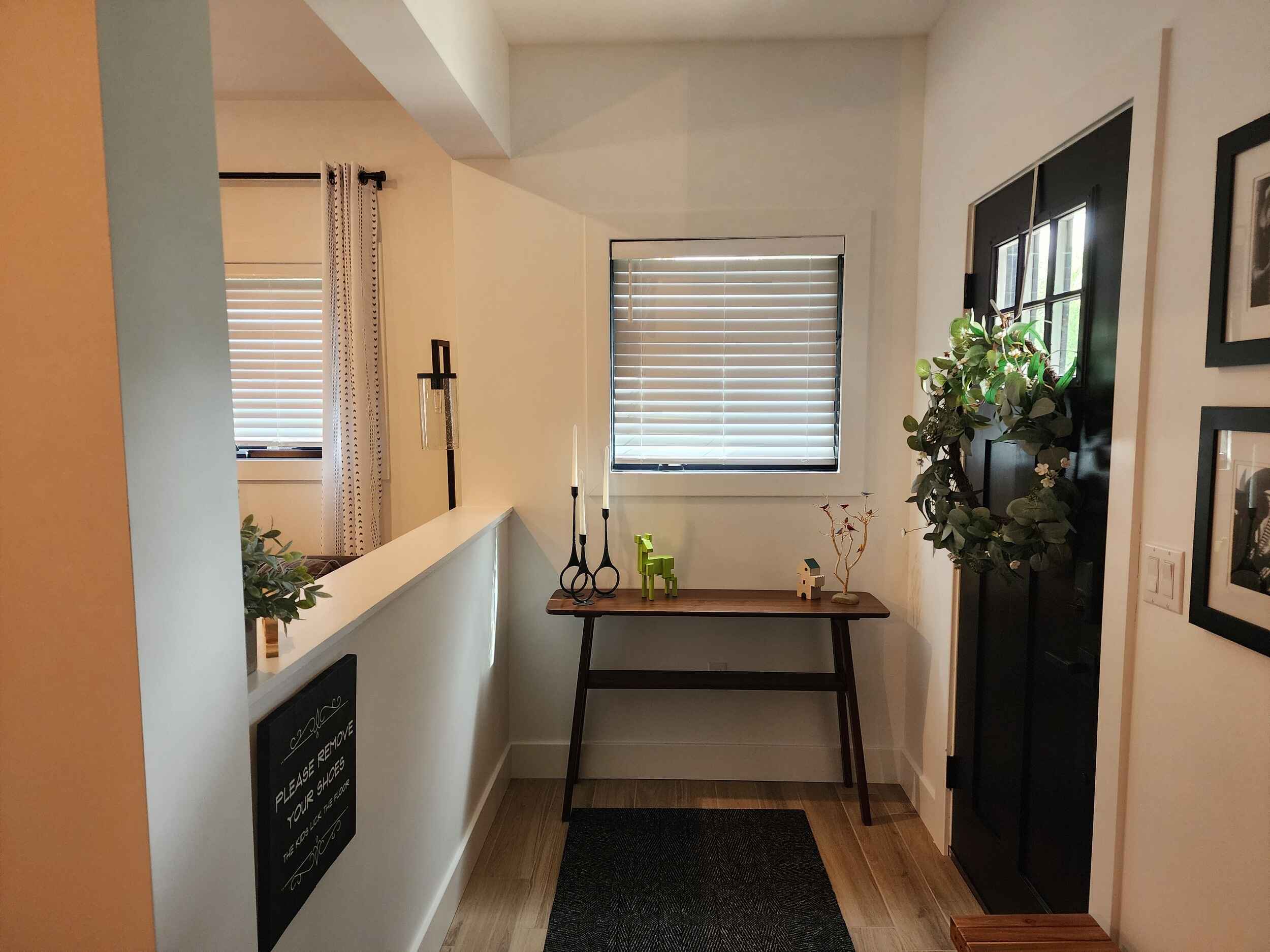 Entryway with Black Door and Green Wreath